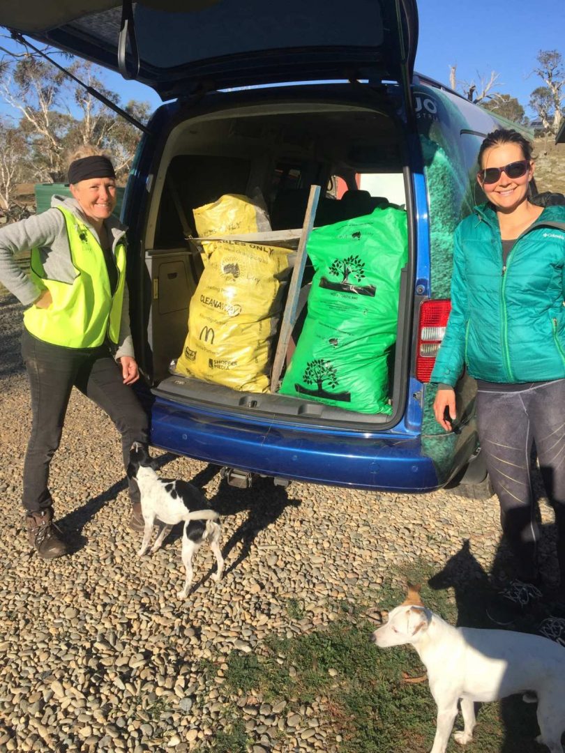Petra Richter and Petra Tesarova standing next to van with collected rubbish in it.
