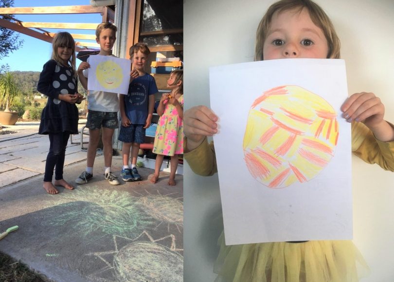 Bega Valley kids holding drawings of the sun.