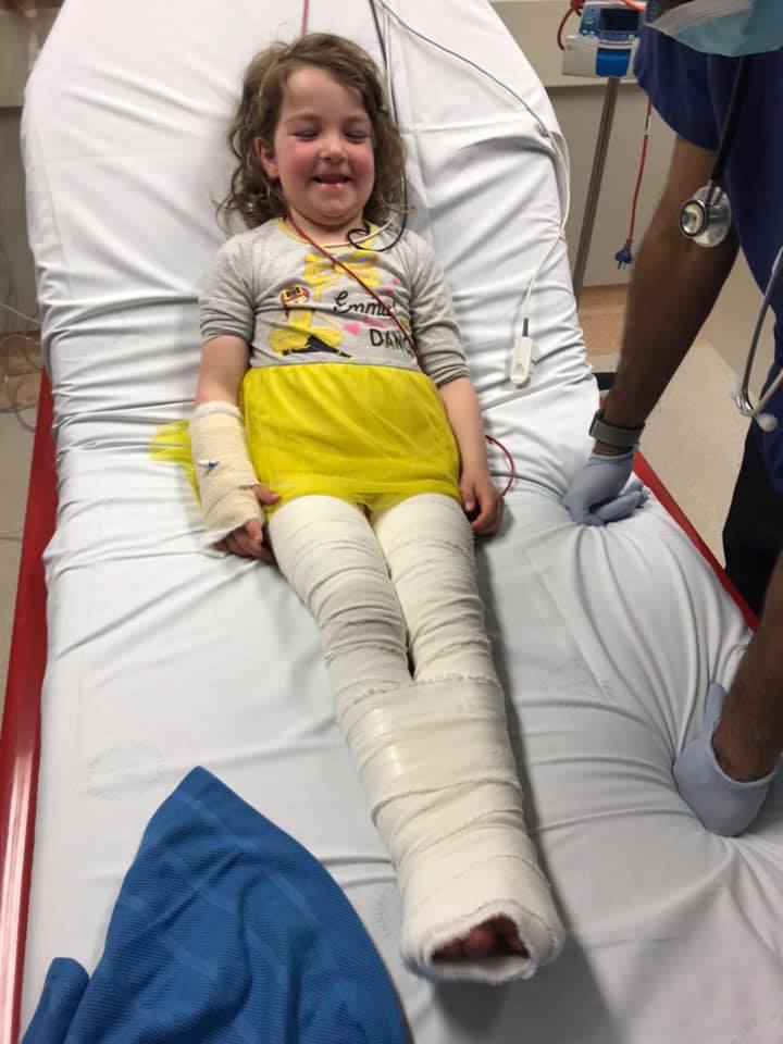 Gabby McDonald bandaged in hospital bed.