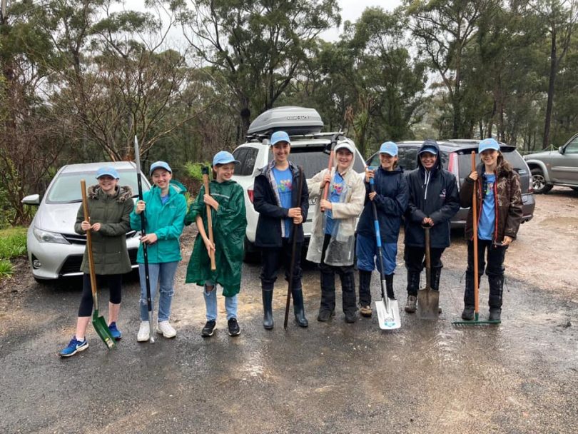 Connecting Communities Australia volunteers cleaning up after bushfires in Bega Valley.