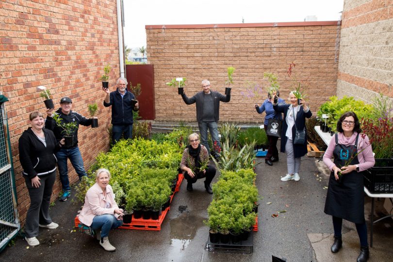 South Coast residents holding plants donated by TAFE NSW.
