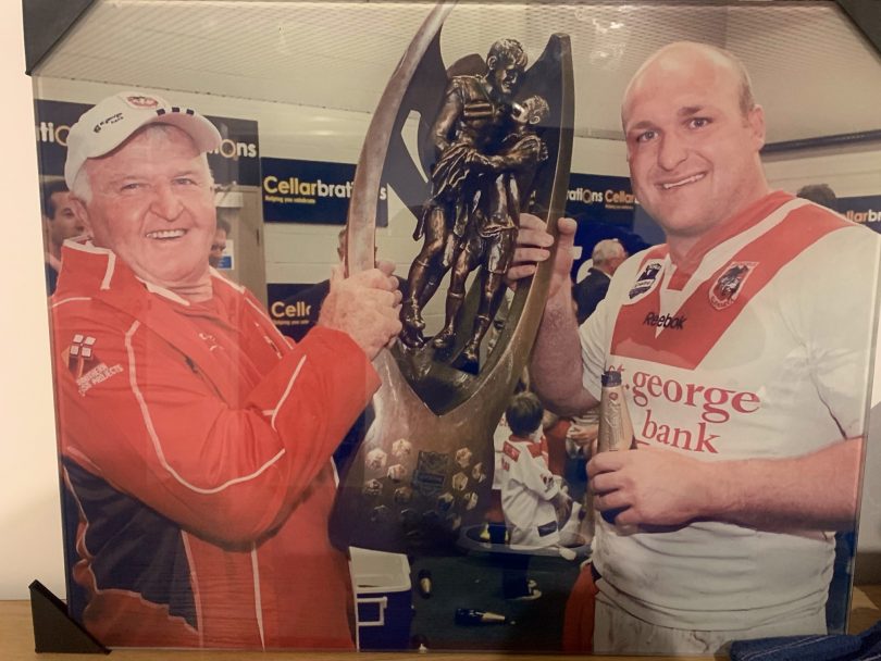 Ack and Mick Weyman holding NRL Premiership trophy.