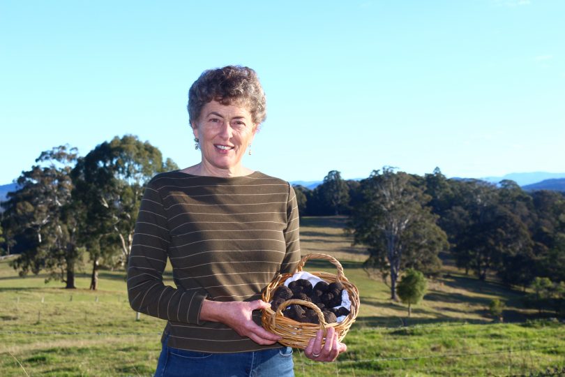 A woman holding a basket of truffles