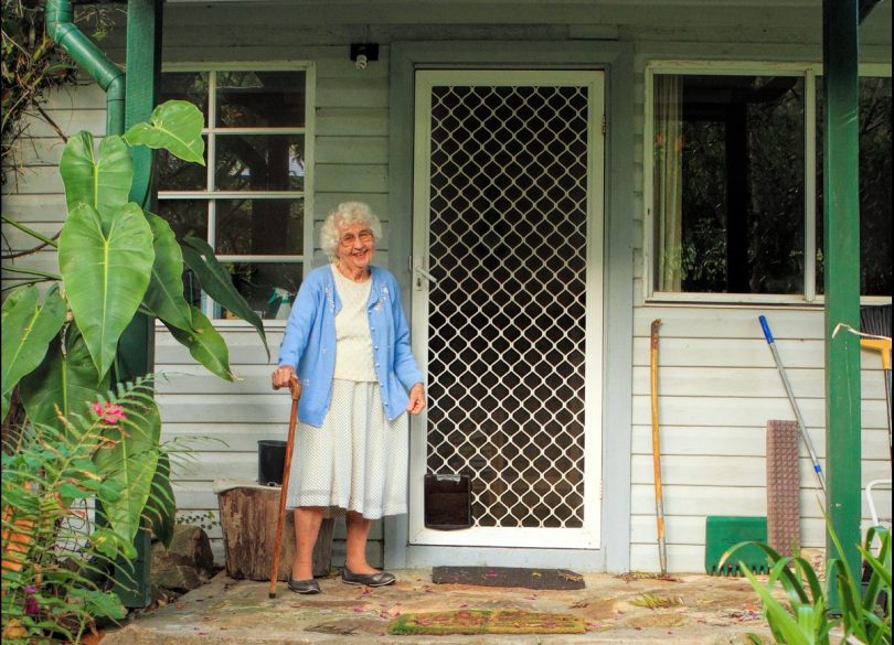 Dr Mary White standing at front door of home