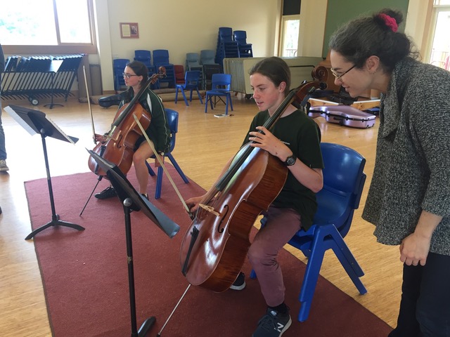 Anna Martin-Scrase teaching cello players Nyah Cockle and Jonakhi Bryant.