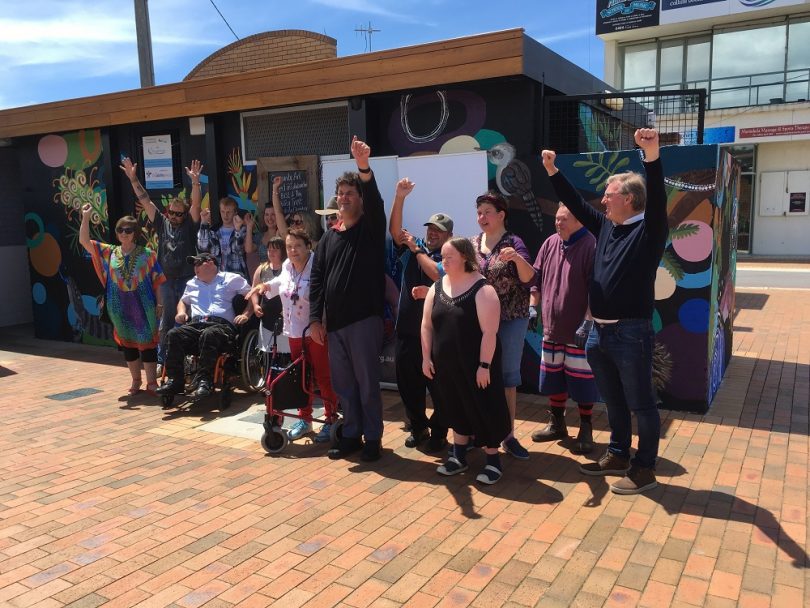 Artists and volunteers celebrate after the completion of mural at Palmer Lane in Merimbula.