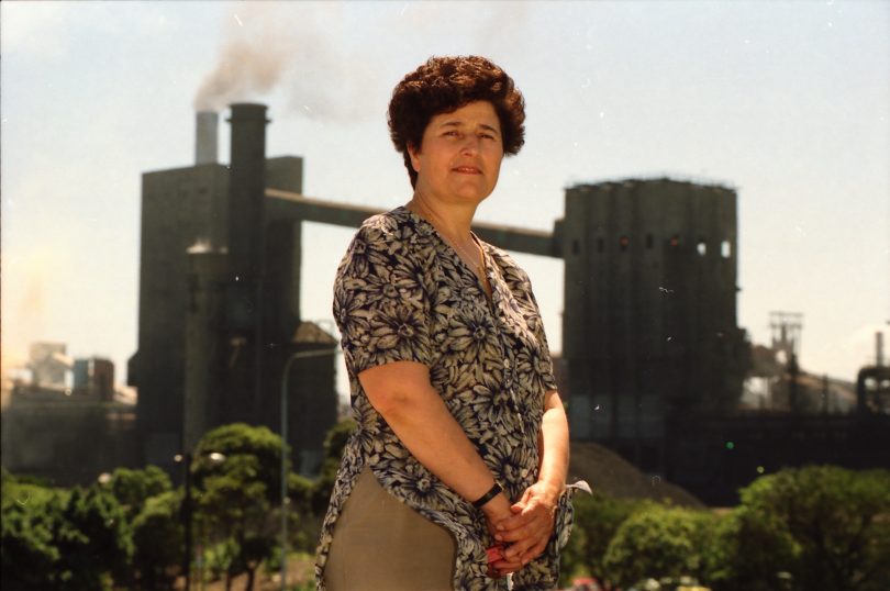 Mara Goluza standing in front of steelworks.