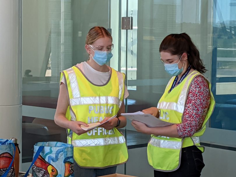 ACT public health officers screen passengers at Canberra Airport.