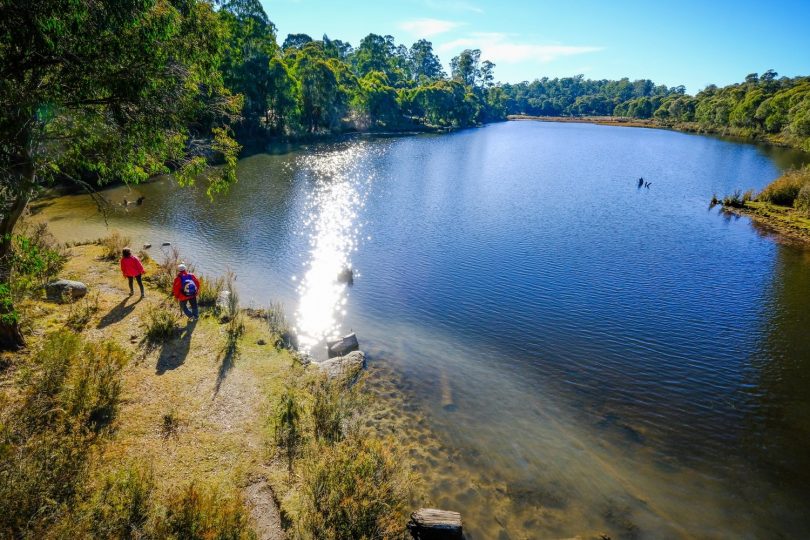 Two walkers at Paddys River Dam on Hume and Hovell Track.