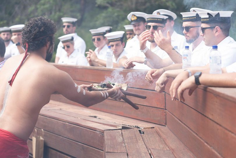 HMAS Supply crew participating in a smoking ceremony at Port of Eden.