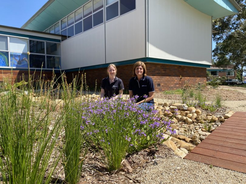 Lily Berry and Courtney Fink-Downes in bush-friendly garden outside Moruya Library.