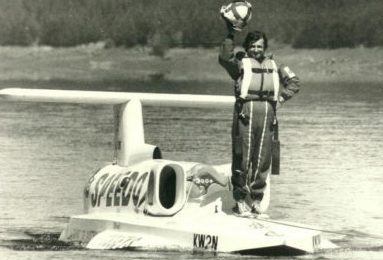 Ken Wharby standing on Spirit of Australia boat on Blowering Dam in 1978.