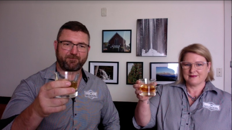 Matt and Linda Rudd holding glasses of bourbon.