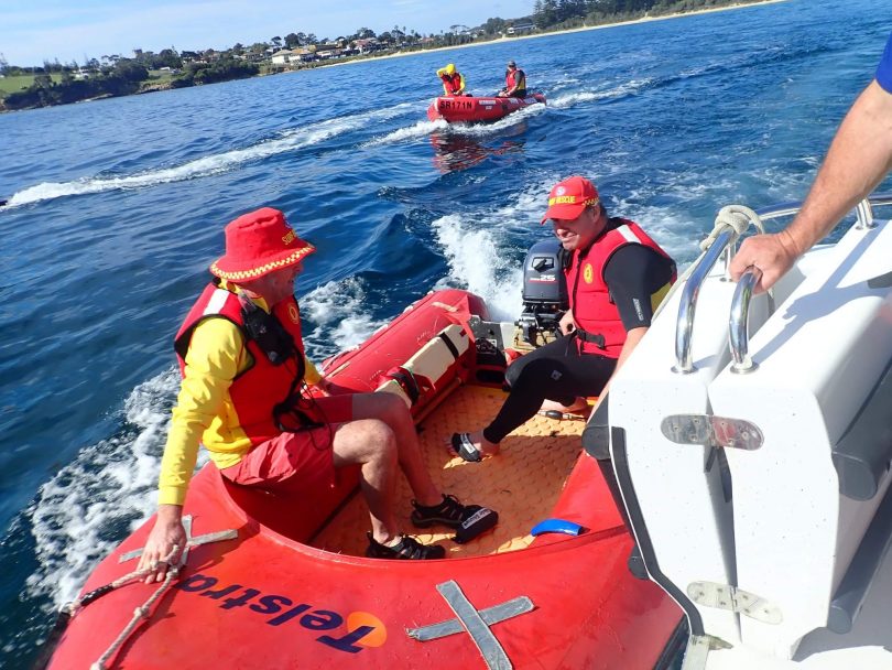Surf lifesavers heading out to sea in boats.
