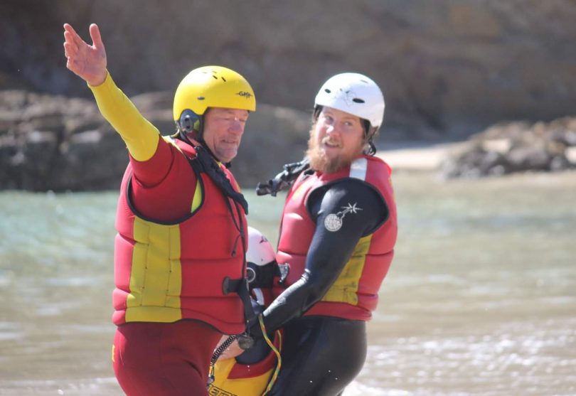 Two surf lifesavers pull a dummy from the water during training.