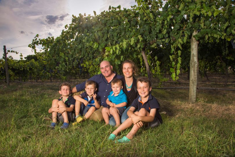 Jason and Alecia Brown with their four sons in vineyard.