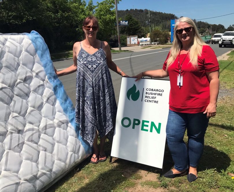 Volunteers holding mattress outside Cobargo Bushfire Relief Centre.