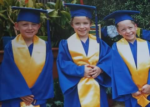 Emme, Kade and Jace in graduation clothes.