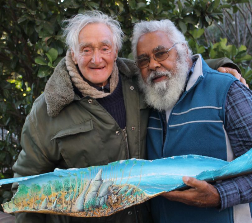 Jack Featherstone and Uncle Max Harrison holding artwork in Braidwood in 2015.