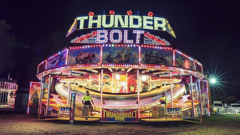 Thunderbolt carnival ride at night.