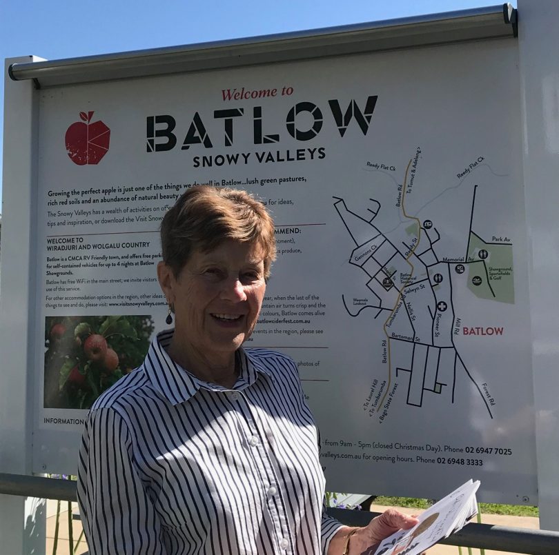 Margaret Sedgwick standing next to Batlow sign.