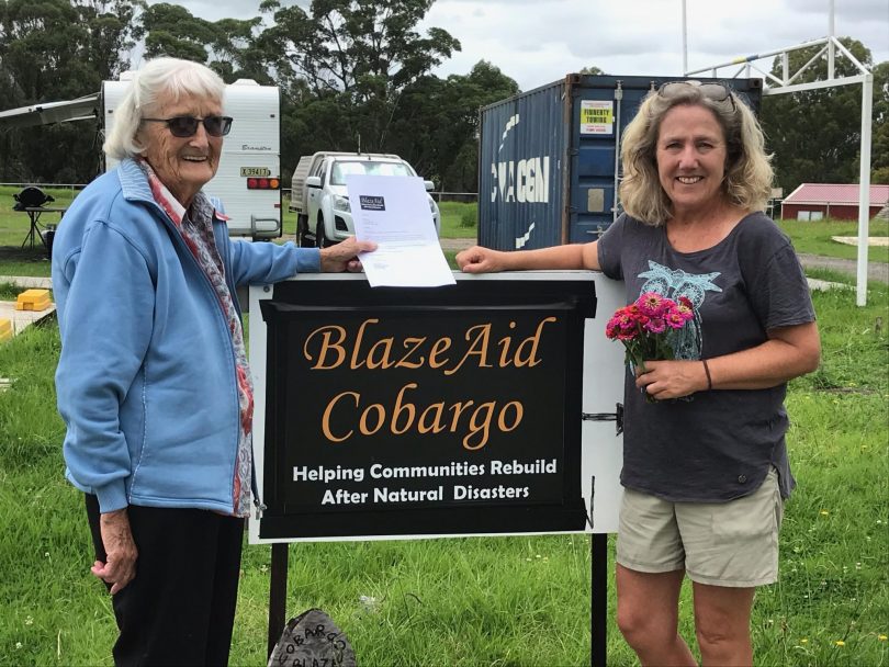 May Blacka presenting donation to Jude Turner from BlazeAid Cobargo.