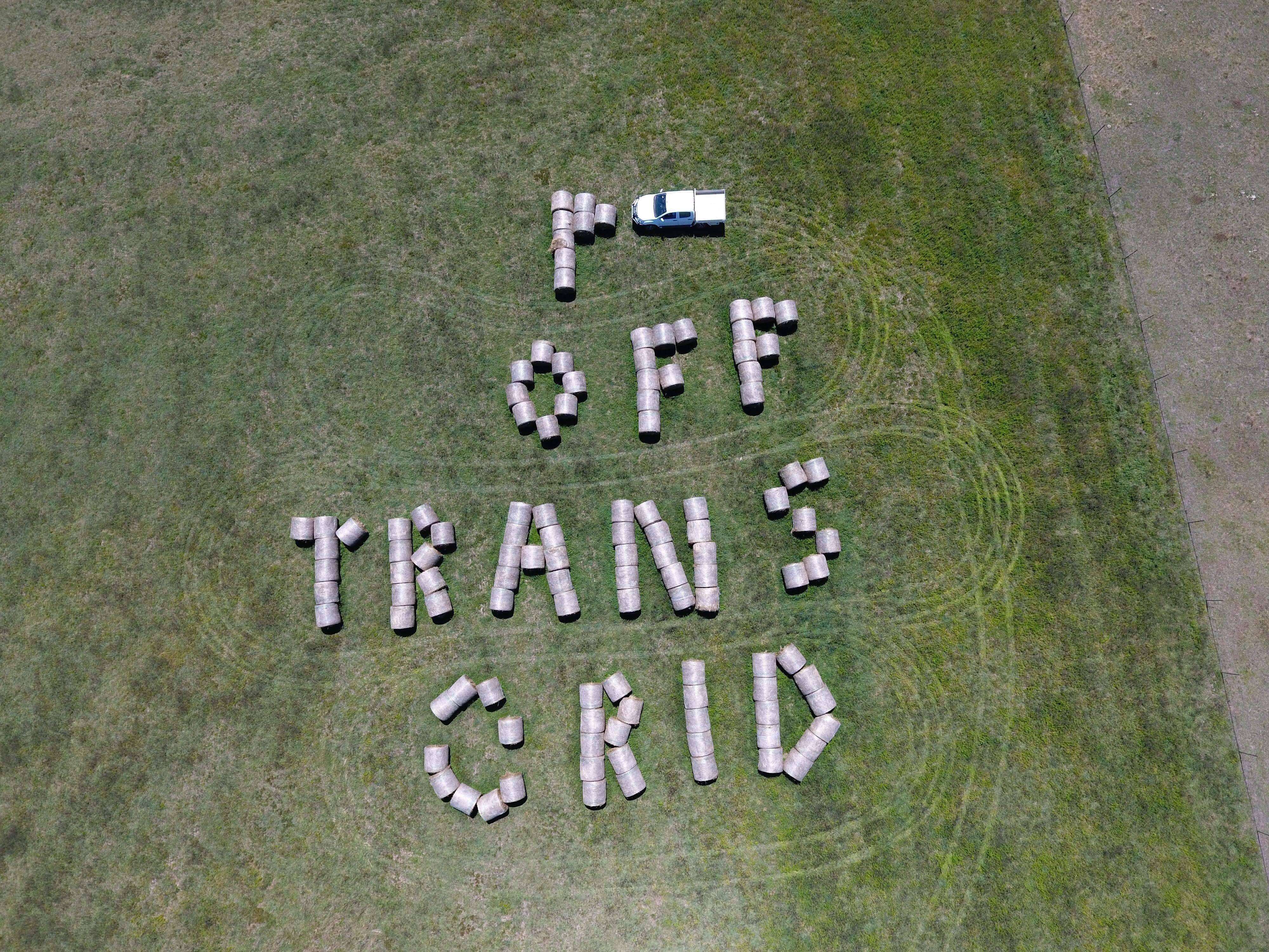 NSW farmer creates hay bale sign to protest against powerline project