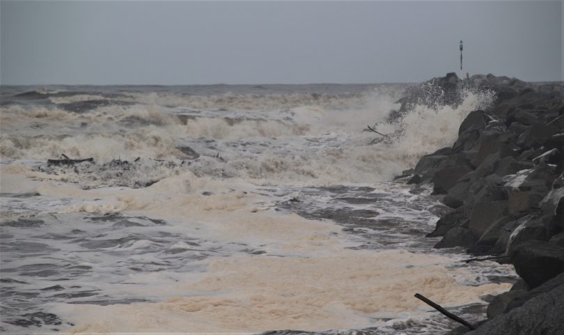 Sea foam on Moruya River at high tide after heavy rain. 