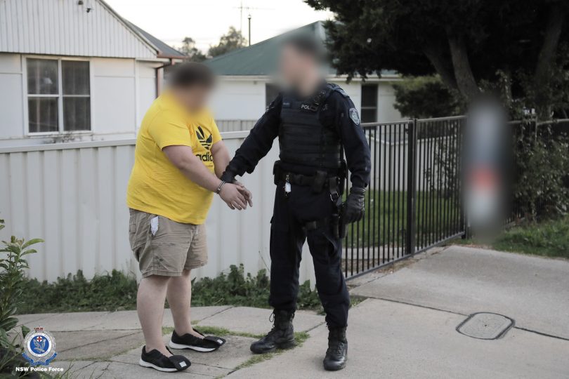 Police arresting a man in Goulburn