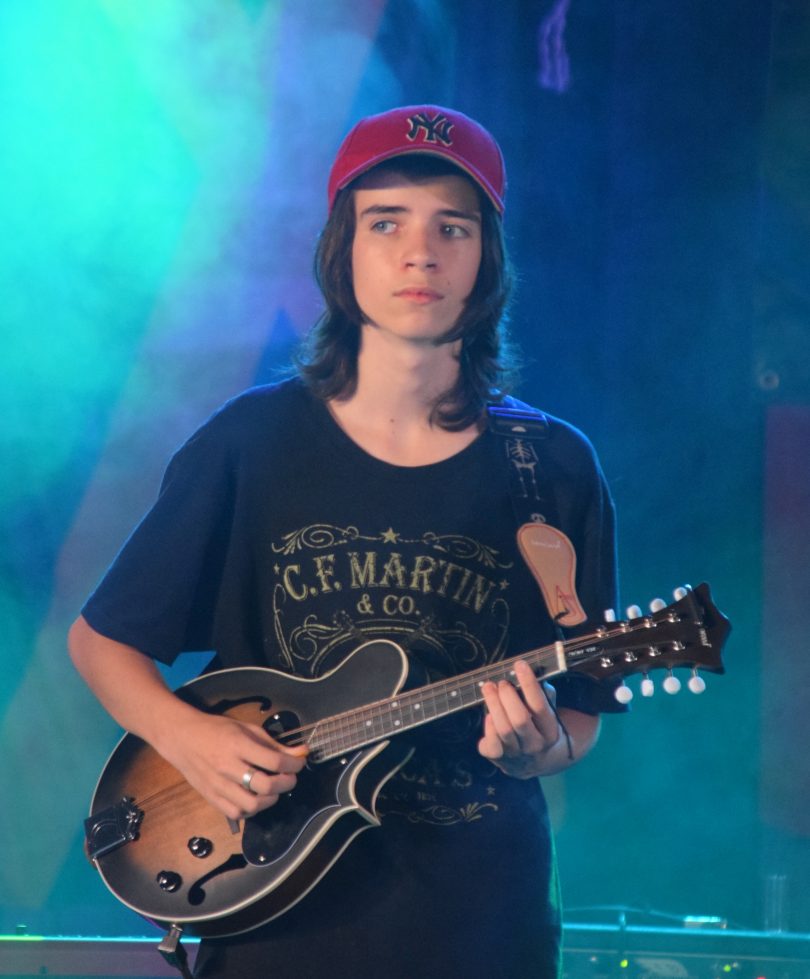 Callum White performing onstage with mandolin