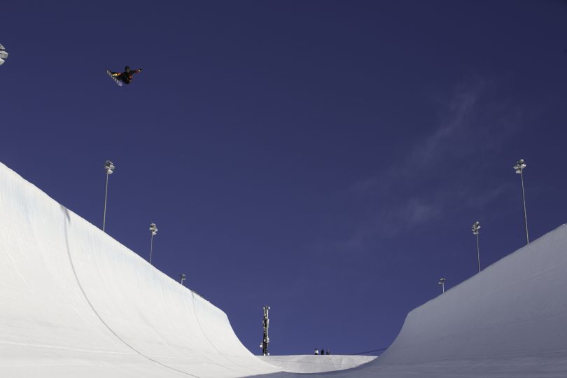 Valentino Guseli airborne on snowboard halfpipe