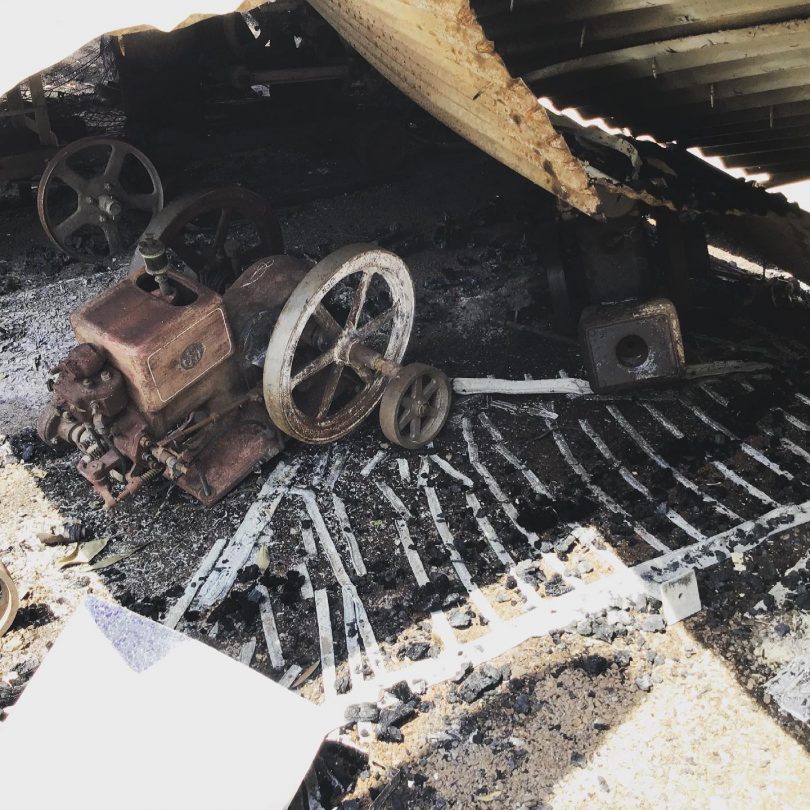 Burnt antique machinery in destroyed shed