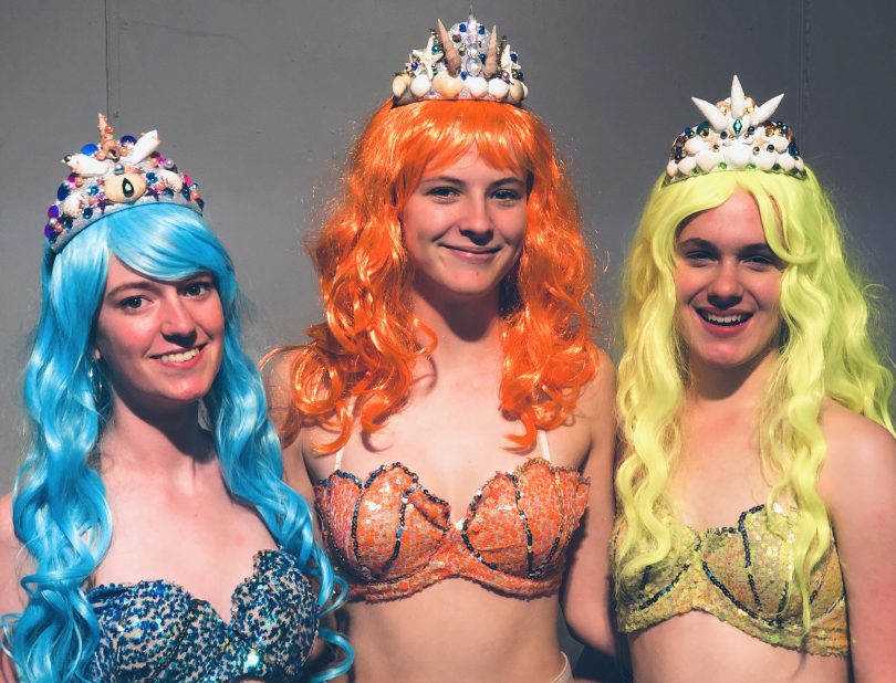 Three actors in costume from The Little Mermaid
