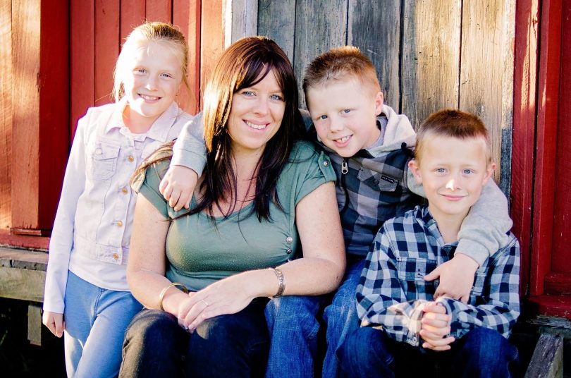 Tracey Beasley surrounded by her three children