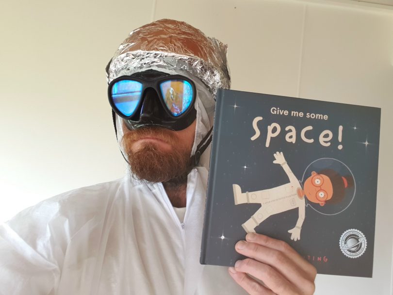 Paul West holding 'Give Me Some Space!' children's book