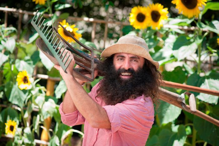 Costa Georgiadis holding gardening tools