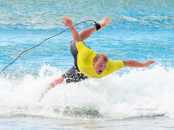 Man falling off surfboard