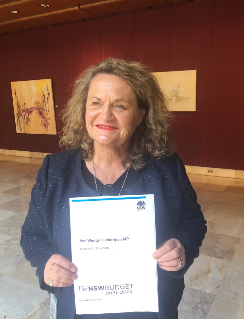 Wendy Tuckerman holding copy of 2021-2022 NSW Budget
