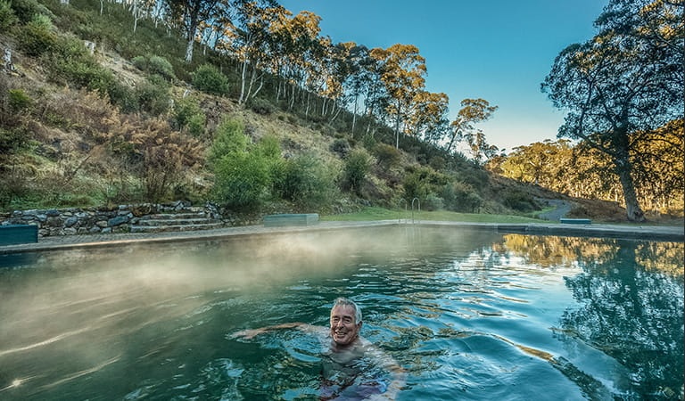 Man swimming in thermal pool