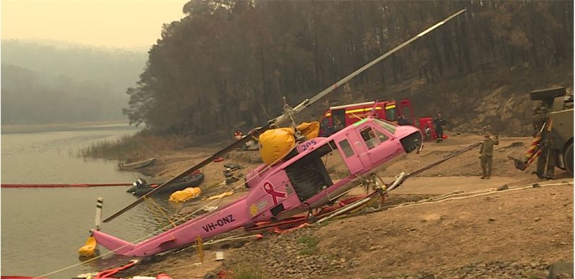 The crashed helicopter being recovered from Ben Boyd Reservoir.