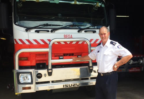Superintendent John Cullen AFSM standing in front of fire truck