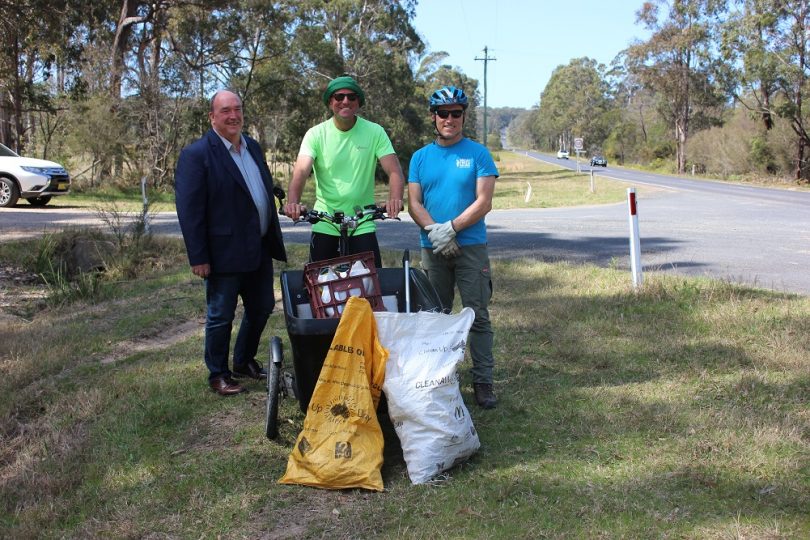 Russell Fitzpatrick, Dane Waites and Doug Reckord with bags of roadside rubbish