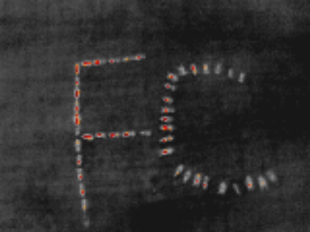 Forestry Corporation of NSW firefighters lying on ground forming letters 'FC', as seen through infrared imaging