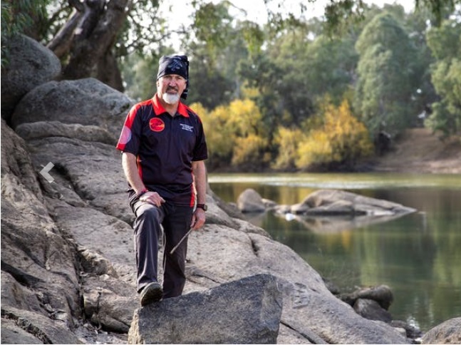 Mark Saddler standing by river