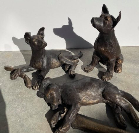 Three bronze pup statues in Gundagai