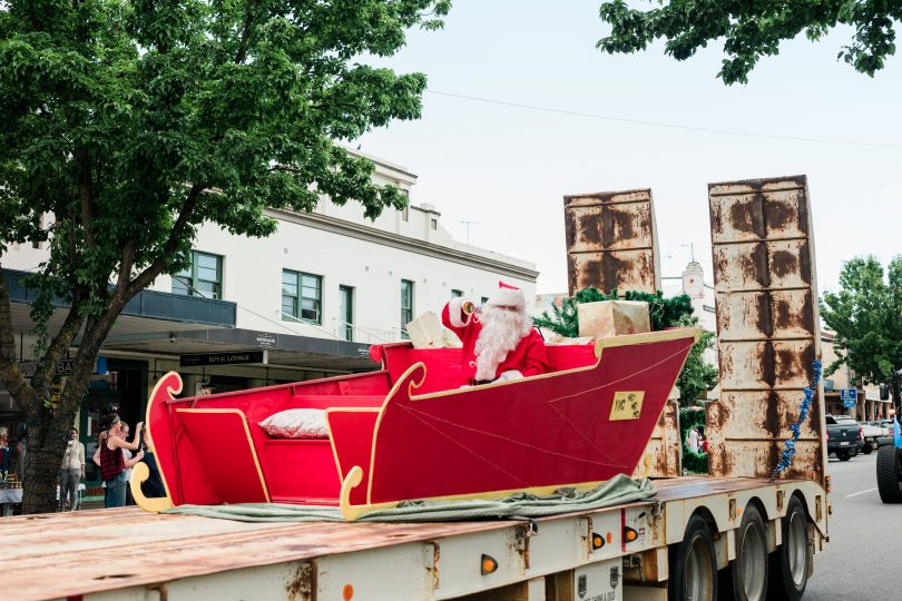Santa in sleigh on flatbed truck