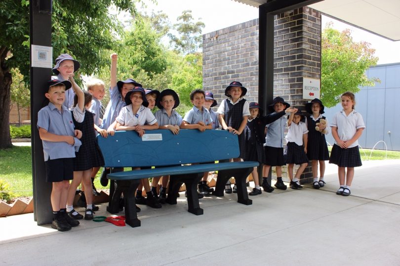 Children from Lumen Christi Catholic College with recycled plastic bench