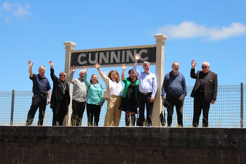 Group of people in front of Gunning Railway Station sign