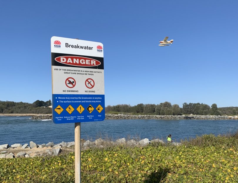 A sign warning of the dangers at the North Moruya breakwall