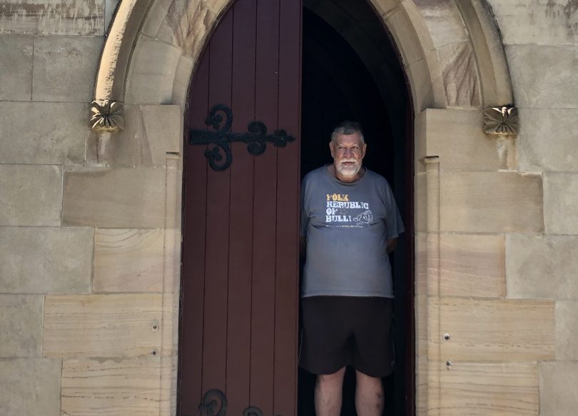 Man standing at church entrance